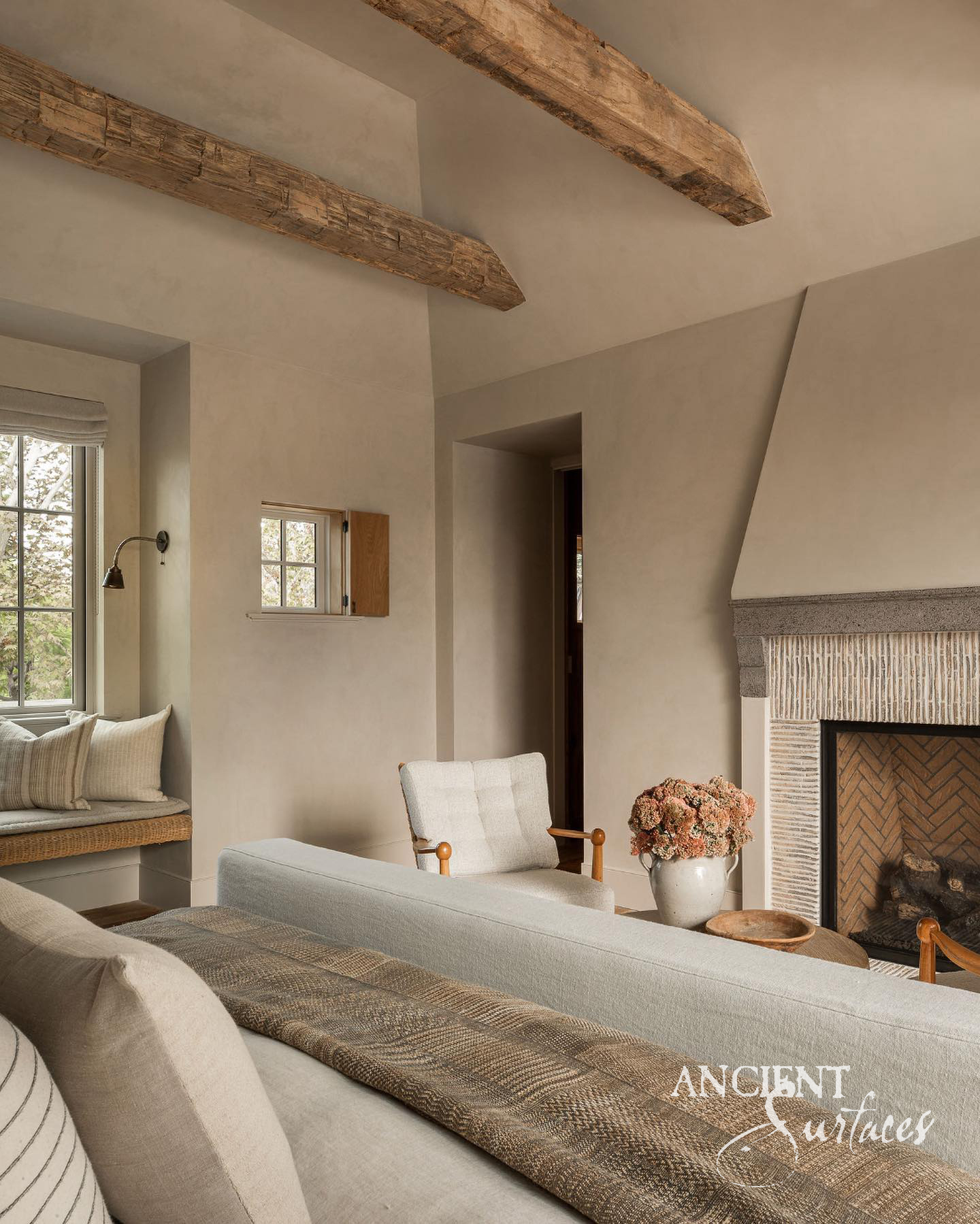 Antique reclaimed limestone mantel in a softly lit European interior
